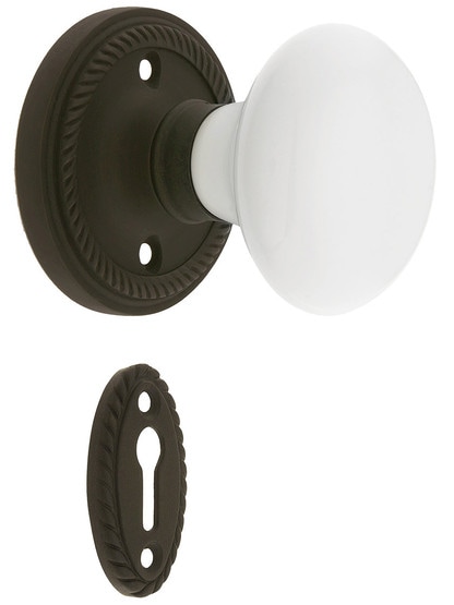 Rope Rosette Mortise Lock Set With White Porcelain Door Knobs in Oil-Rubbed Bronze.